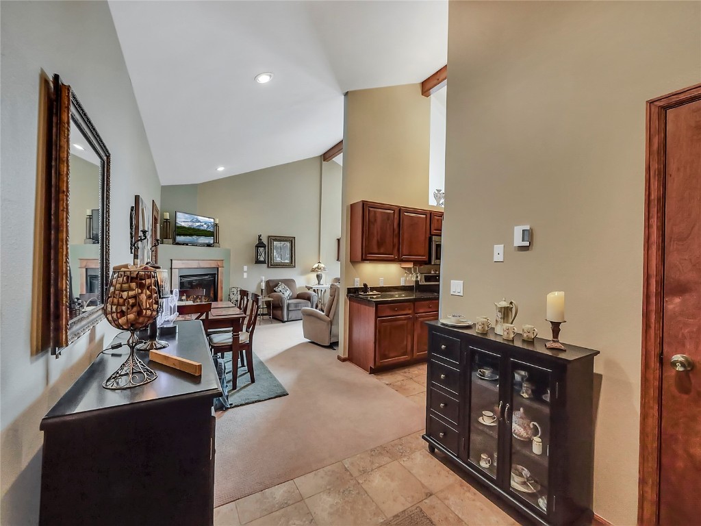 3710 Ryan Gulch Road, Unit 3710 Silverthorne, CO 80498 - Photo 15 of 50 a living room with furniture a flat screen tv and kitchen view