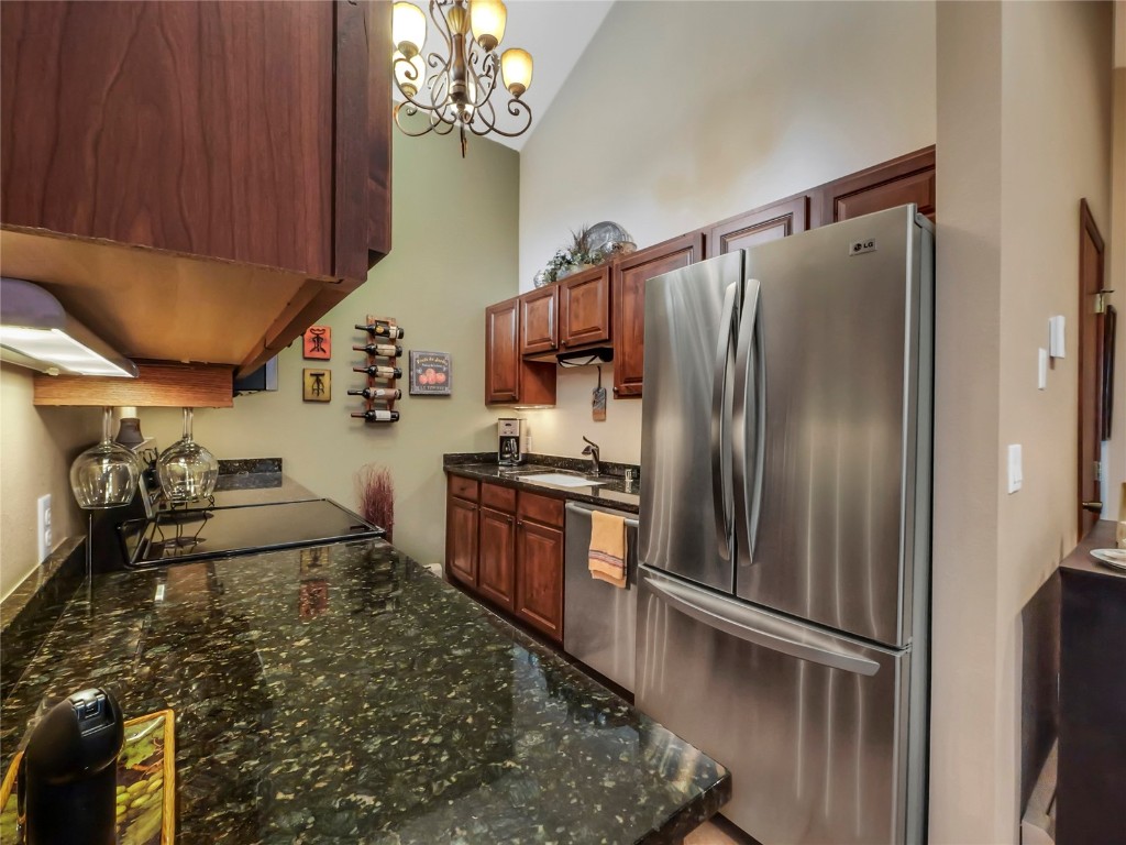 3710 Ryan Gulch Road, Unit 3710 Silverthorne, CO 80498 - Photo 17 of 50 a kitchen with kitchen island granite countertop a refrigerator stove and sink