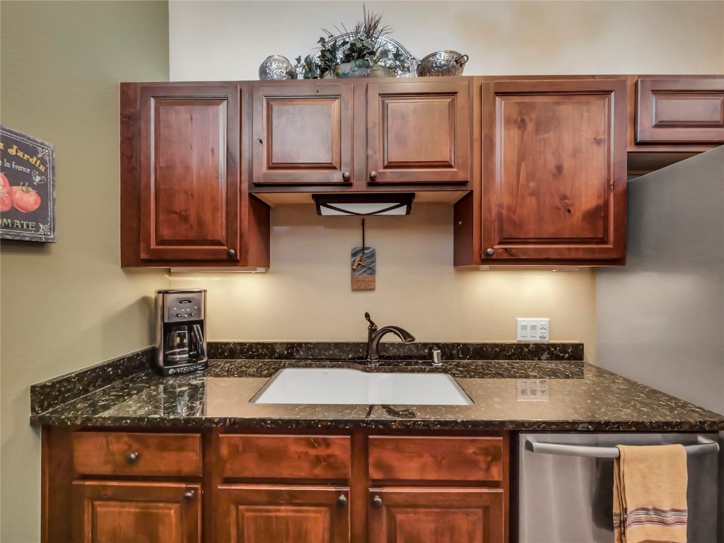 3710 Ryan Gulch Road, Unit 3710 Silverthorne, CO 80498 - Photo 18 of 50 a kitchen with granite countertop a sink a stove and cabinets