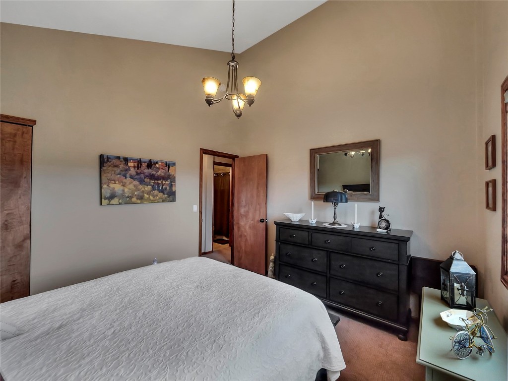 3710 Ryan Gulch Road, Unit 3710 Silverthorne, CO 80498 - Photo 24 of 50 a bedroom with a bed and a flat screen tv