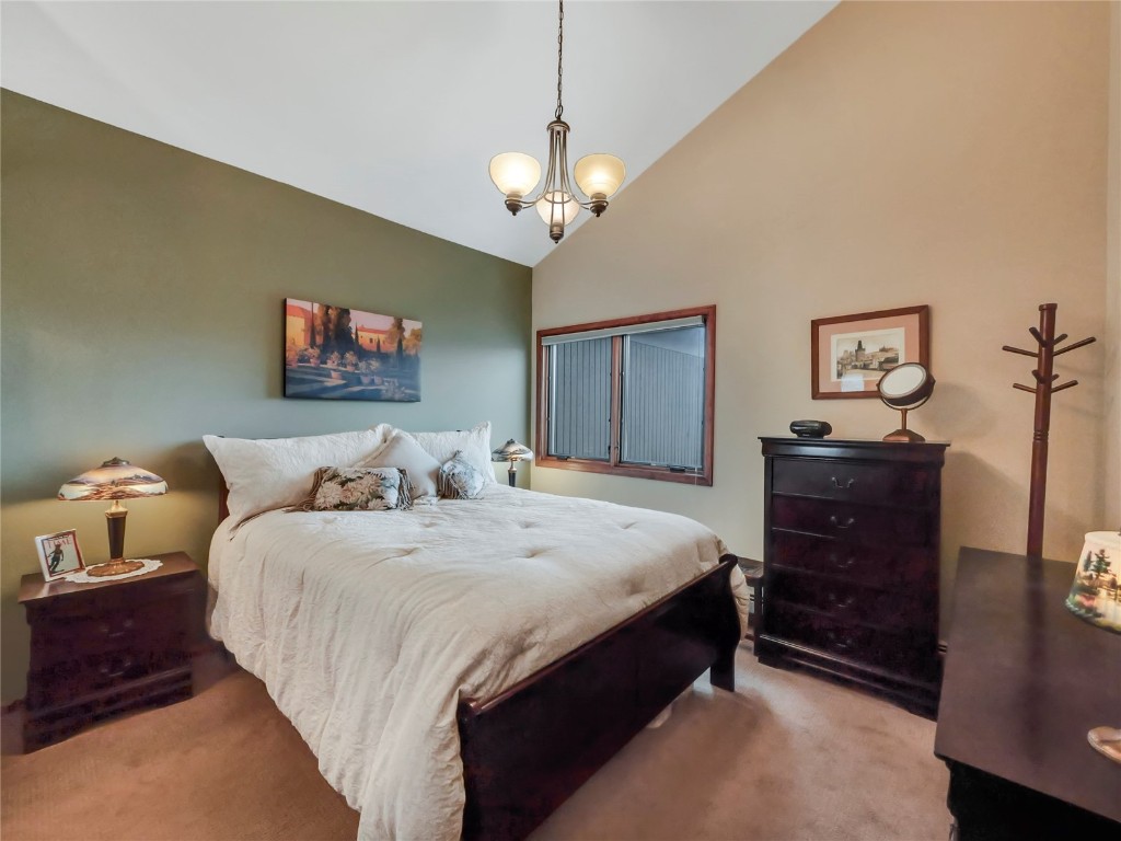 3710 Ryan Gulch Road, Unit 3710 Silverthorne, CO 80498 - Photo 27 of 50 a spacious bedroom with bed and a dresser