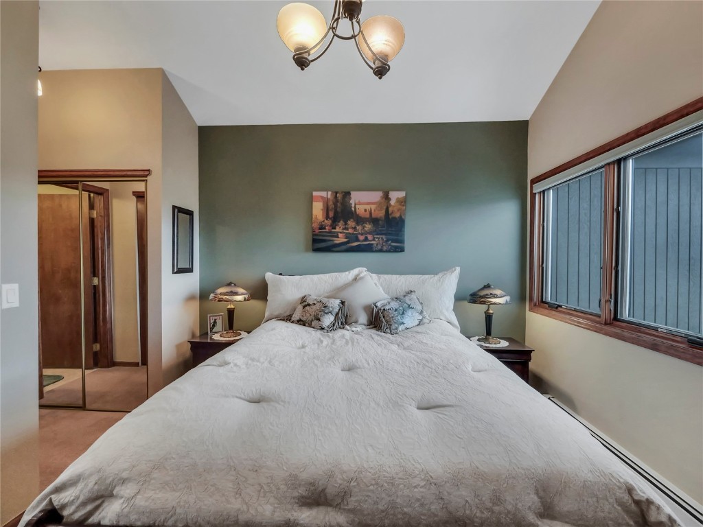 3710 Ryan Gulch Road, Unit 3710 Silverthorne, CO 80498 - Photo 29 of 50 a bedroom with a bed and a painting on the wall