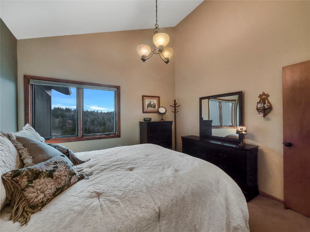 3710 Ryan Gulch Road, Unit 3710 Silverthorne, CO 80498 - Photo 30 of 50 a bedroom with a bed and a dresser