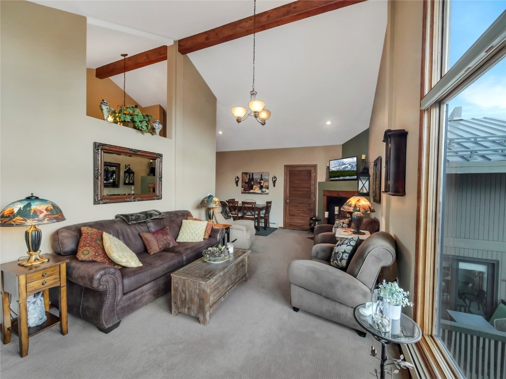 3710 Ryan Gulch Road, Unit 3710 Silverthorne, CO 80498 - Photo 7 of 50 a living room with furniture a ceiling fan and a window