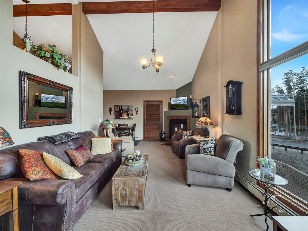 3710 Ryan Gulch Road, Unit 3710 Silverthorne, CO 80498 - Photo 8 of 50 a living room with furniture a ceiling fan and a window