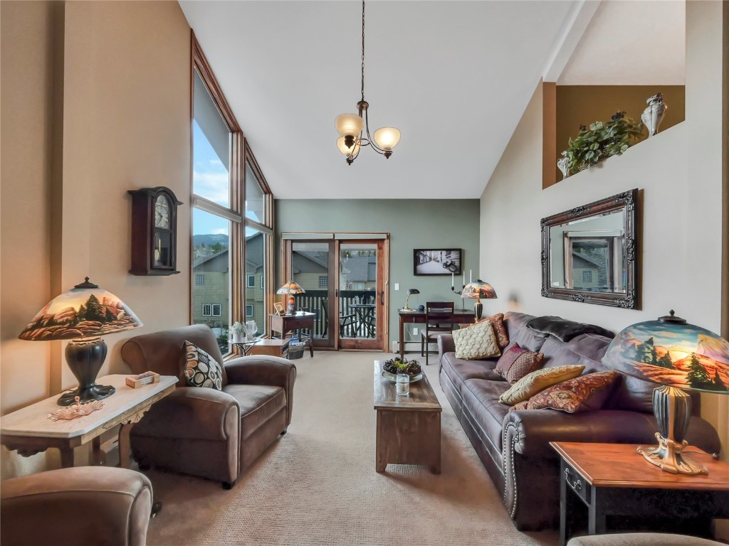 3710 Ryan Gulch Road, Unit 3710 Silverthorne, CO 80498 - Photo 10 of 50 a living room with furniture ceiling fan and a window