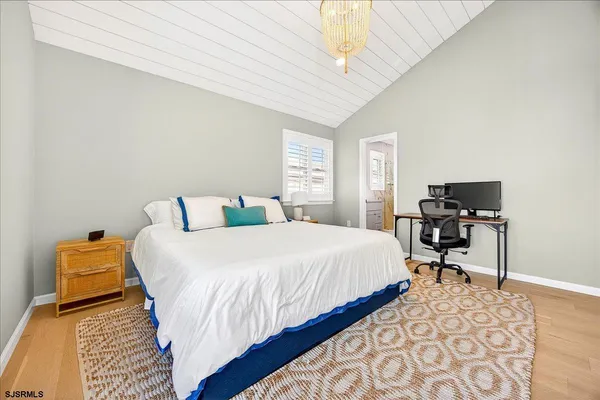 a bedroom with bed and chair