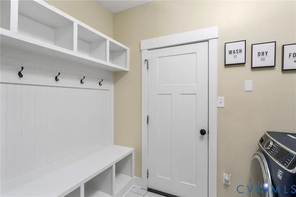 a spacious bedroom with a bed a couch and a window
