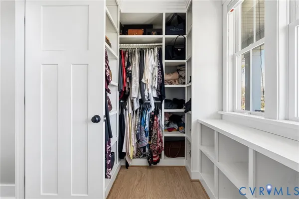 a large bed sitting in a bedroom next to a window