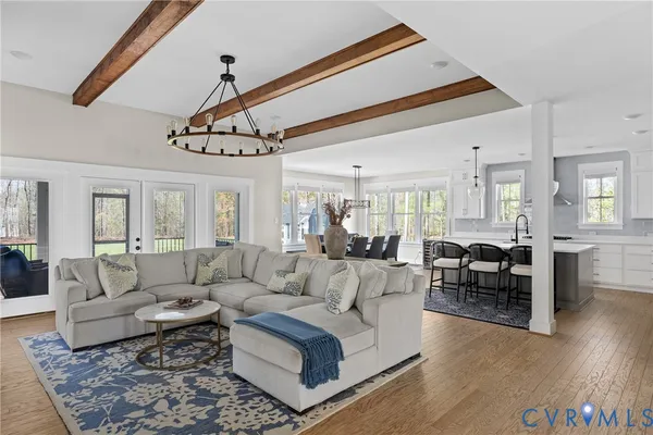 a kitchen with a dining table chairs and cabinets