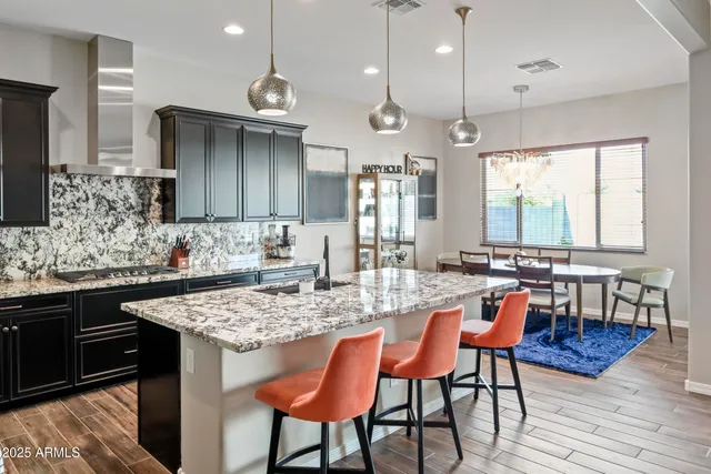 a kitchen with center island table and chairs in it