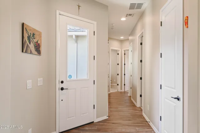 a view of a hallway with wooden floor