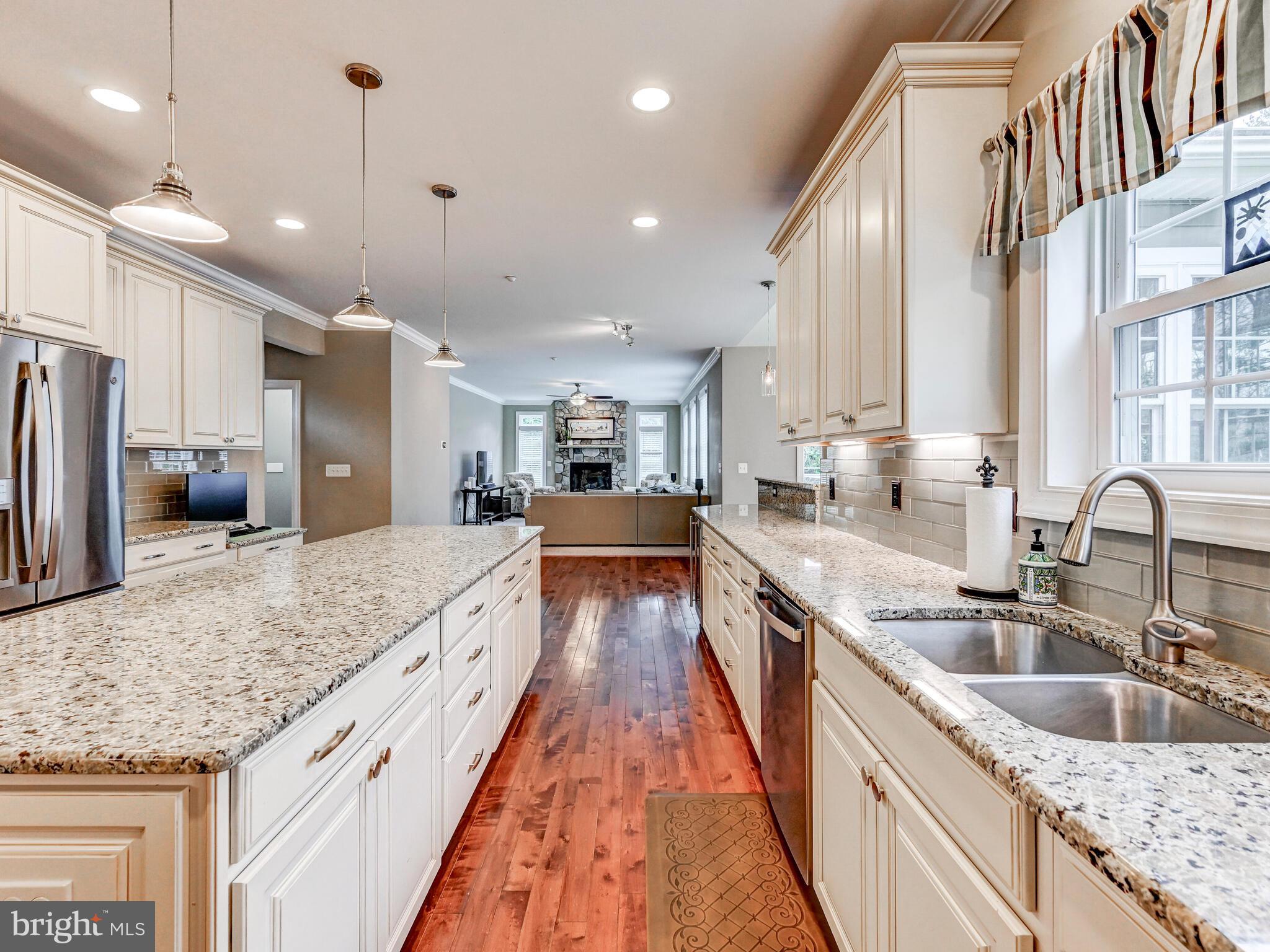 11707 Manor Road Glen Arm, MD 21057 - Photo 11 of 43 a large kitchen with stainless steel appliances granite countertop plenty wooden cabinets counter space a sink and a wooden floor