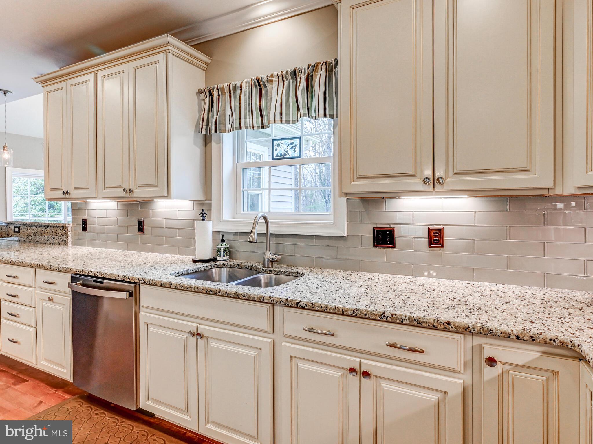 11707 Manor Road Glen Arm, MD 21057 - Photo 12 of 43 a kitchen with granite countertop white cabinets and white appliances