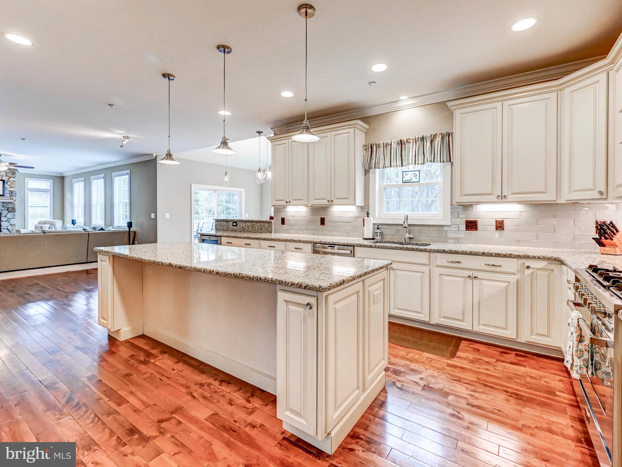 11707 Manor Road Glen Arm, MD 21057 - Photo 13 of 43 a kitchen with stainless steel appliances granite countertop a sink a stove a refrigerator and white cabinets