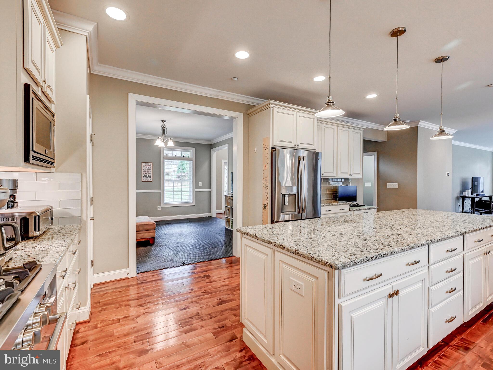 11707 Manor Road Glen Arm, MD 21057 - Photo 14 of 43 a kitchen with kitchen island a counter space a sink appliances and cabinets
