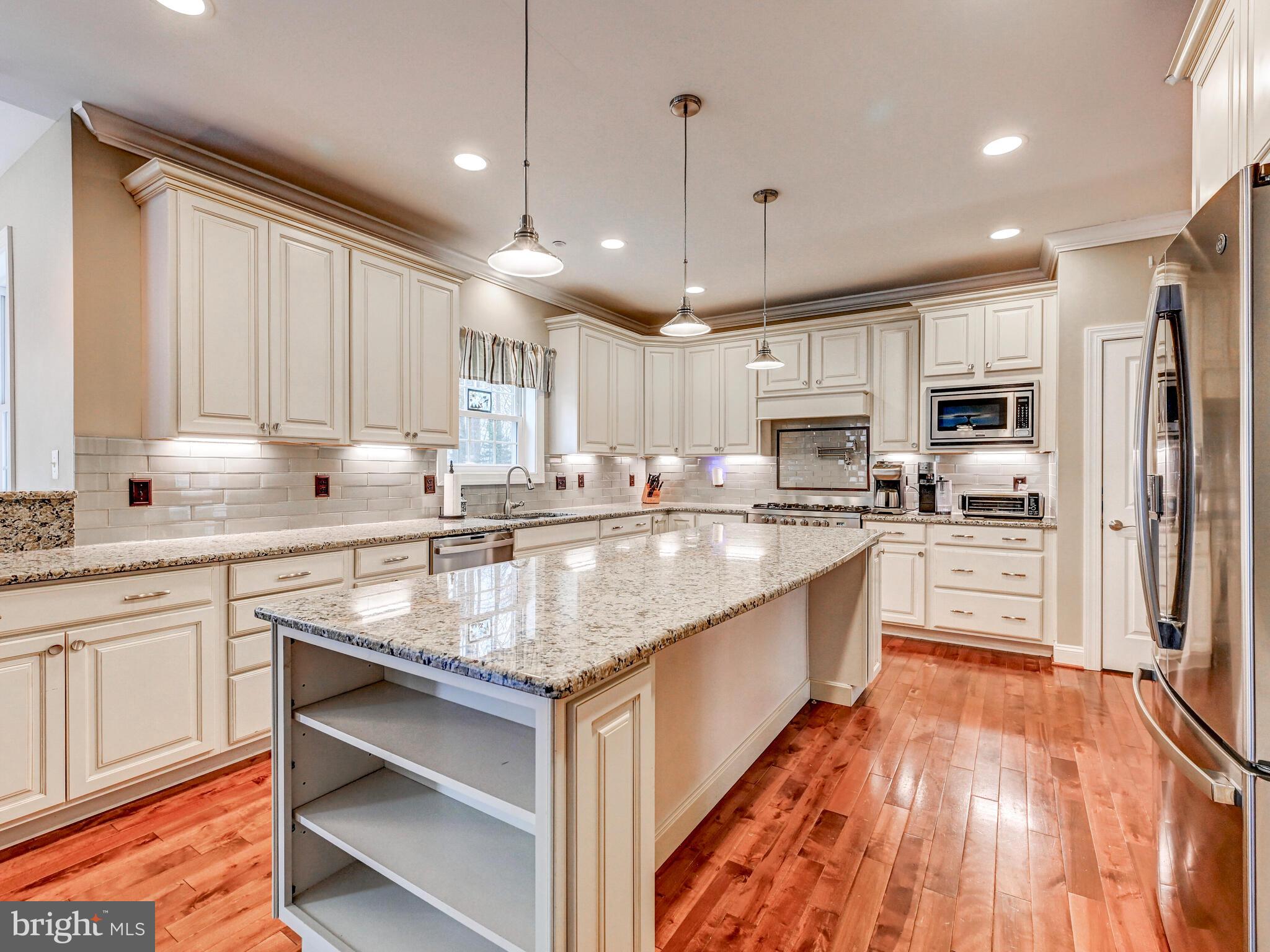 11707 Manor Road Glen Arm, MD 21057 - Photo 15 of 43 a kitchen with stainless steel appliances granite countertop a stove refrigerator and cabinets