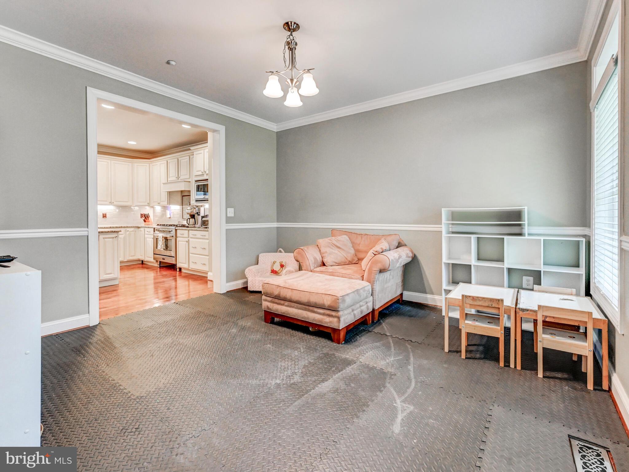 11707 Manor Road Glen Arm, MD 21057 - Photo 16 of 43 a bedroom with furniture and a chandelier