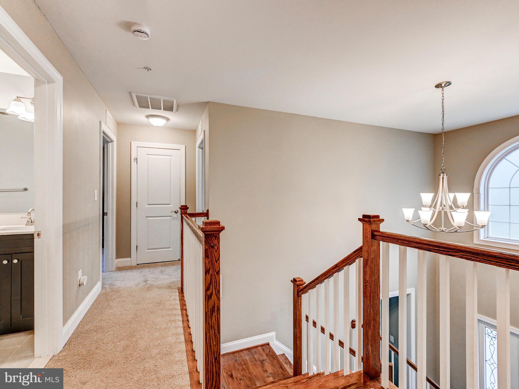 11707 Manor Road Glen Arm, MD 21057 - Photo 22 of 43 a view of a hallway with a chandelier