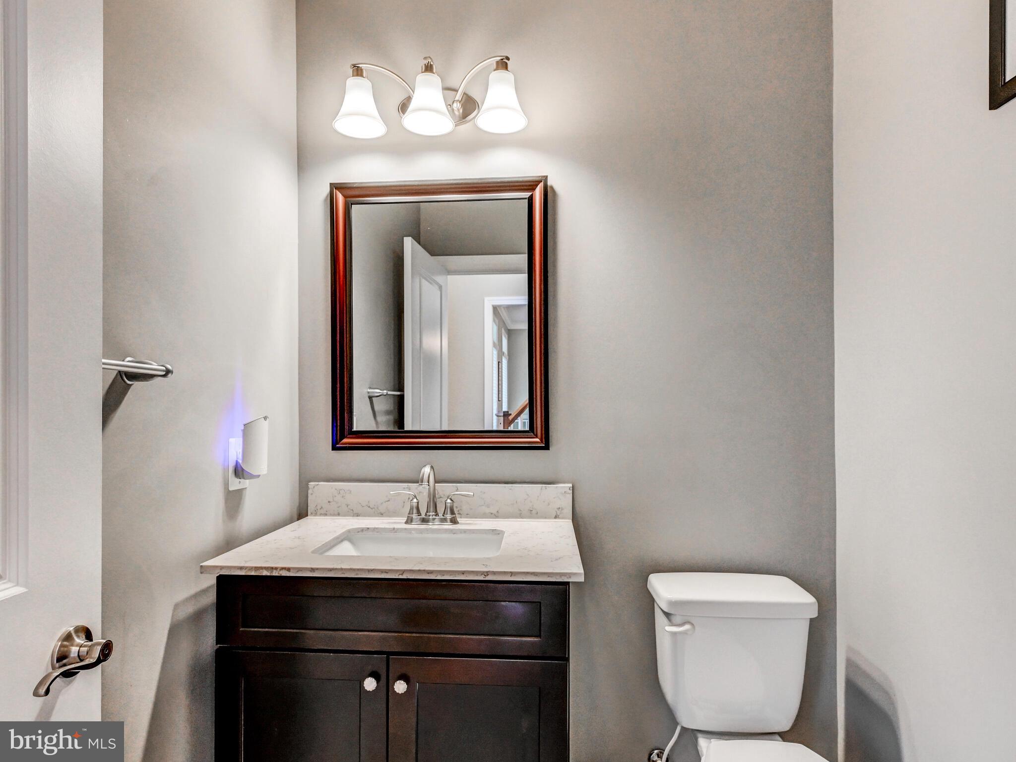 11707 Manor Road Glen Arm, MD 21057 - Photo 26 of 43 a bathroom with a toilet sink and mirror