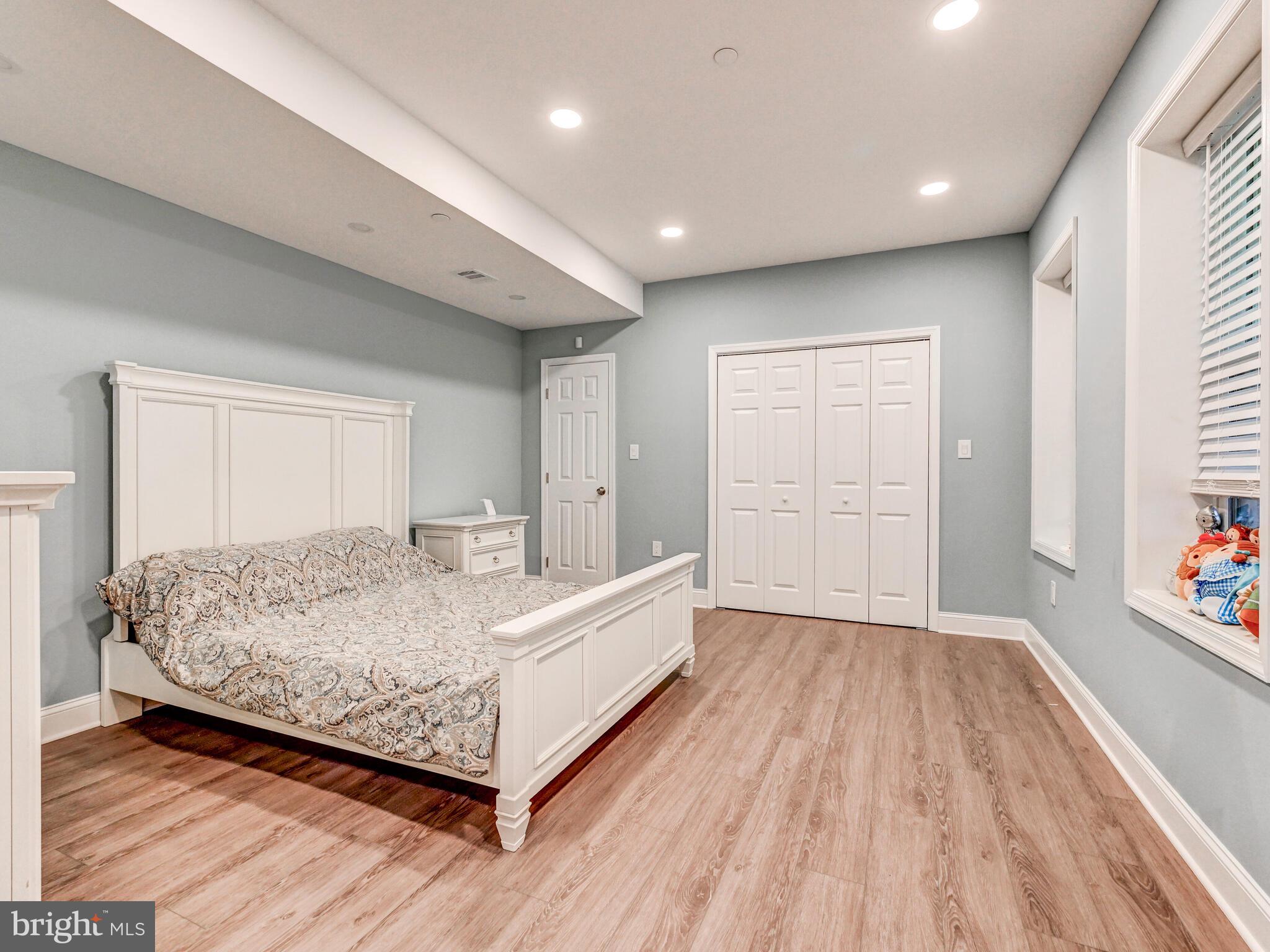 11707 Manor Road Glen Arm, MD 21057 - Photo 28 of 43 a large bedroom with a bed and wooden floor