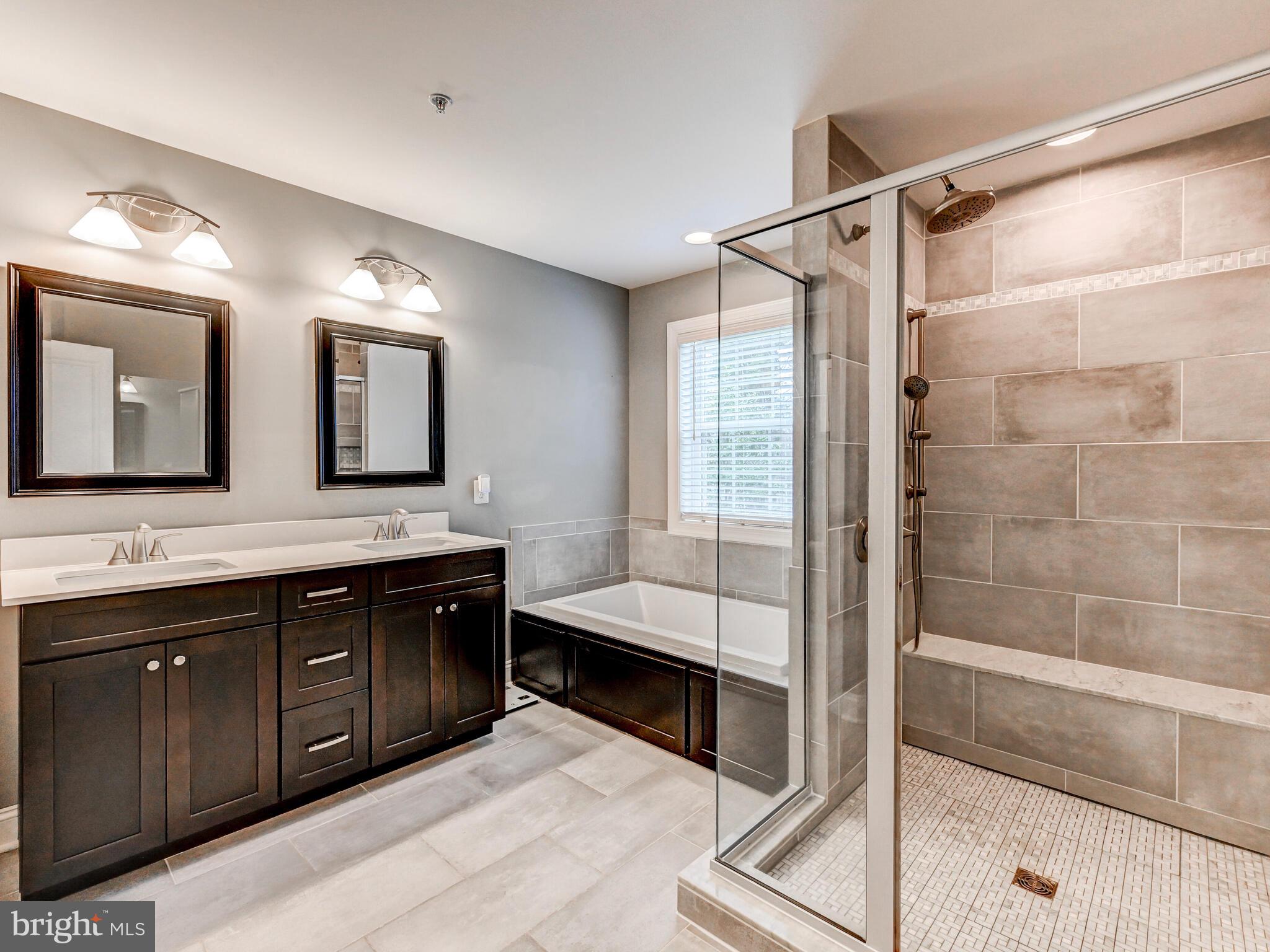 11707 Manor Road Glen Arm, MD 21057 - Photo 29 of 43 a spacious bathroom with a shower sink and mirror
