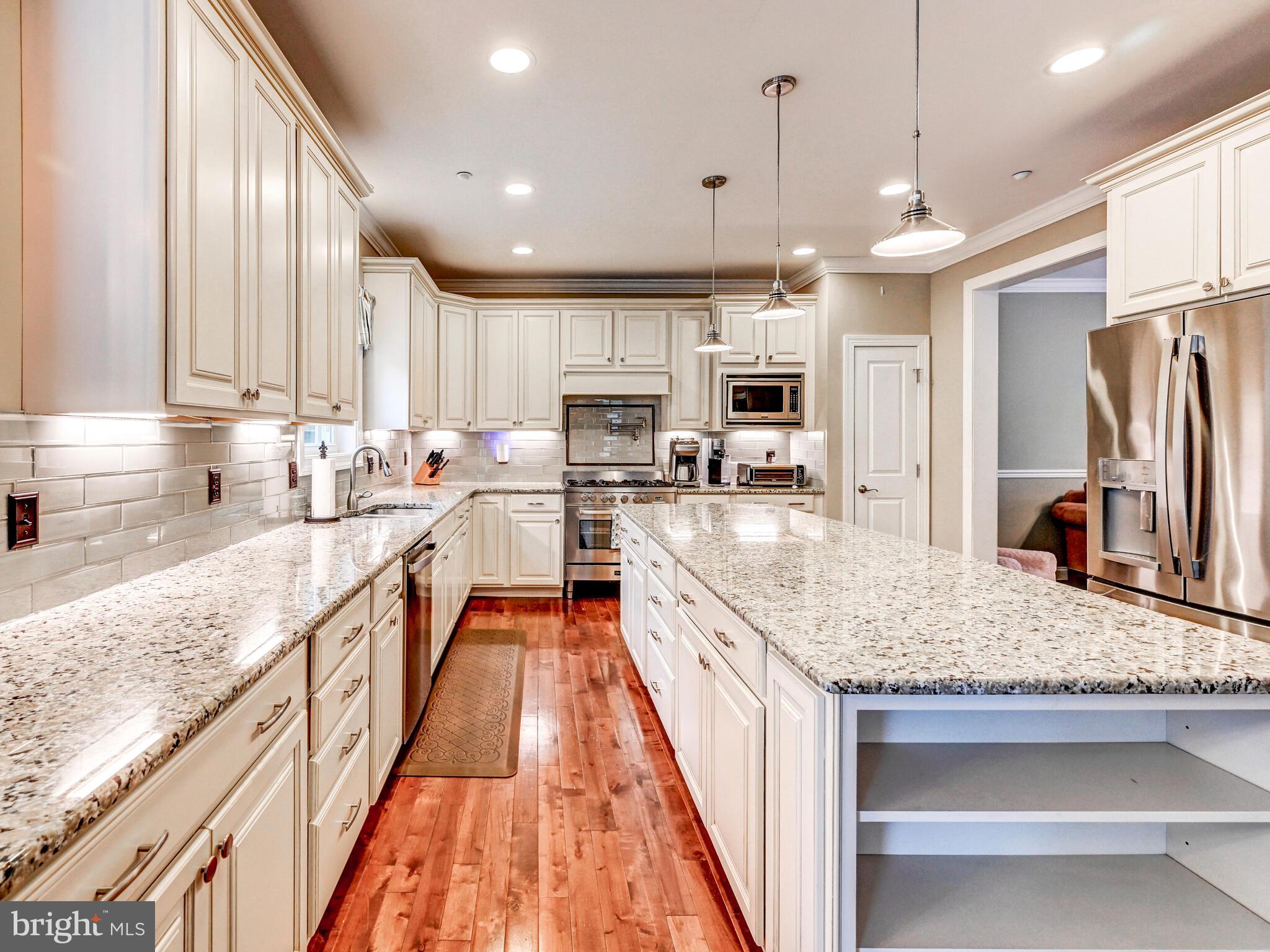 11707 Manor Road Glen Arm, MD 21057 - Photo 9 of 43 a large kitchen with stainless steel appliances granite countertop a sink stove and refrigerator