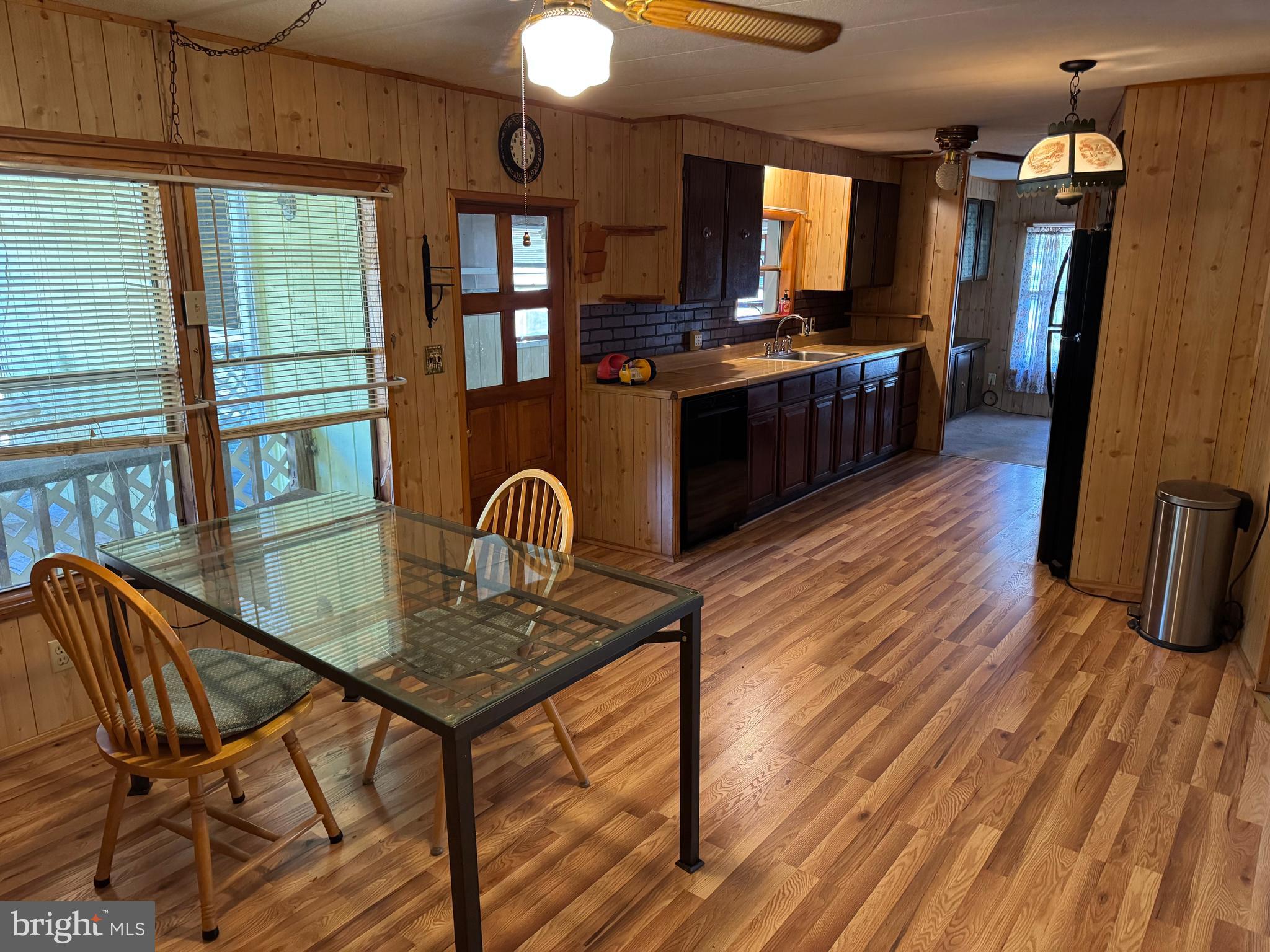 127 Wood Duck Lane Chestertown, MD 21620 - Photo 11 of 26 a kitchen with stainless steel appliances granite countertop a stove top oven a dining table and chairs with wooden floor