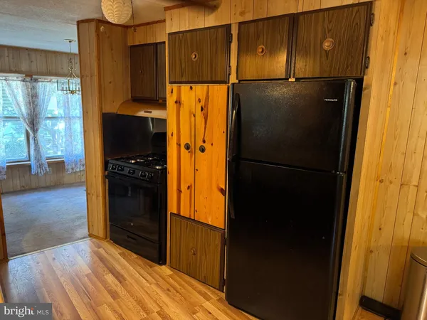 a kitchen with a refrigerator and a stove top oven