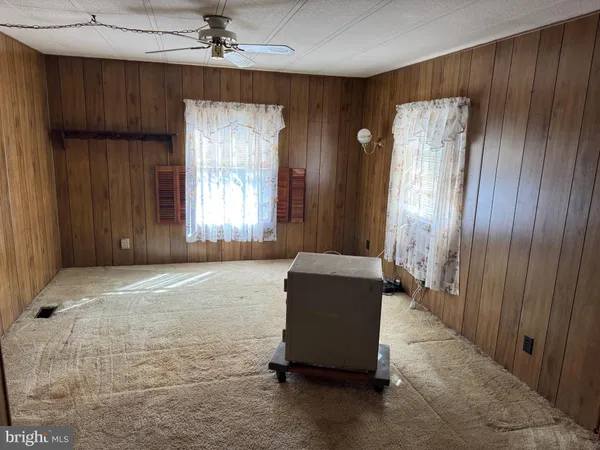 a spacious bedroom with a bed and a window
