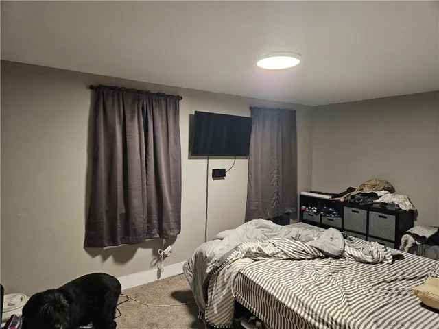 a bedroom with a bed and a television