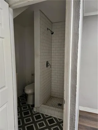 a bathroom with a granite countertop toilet