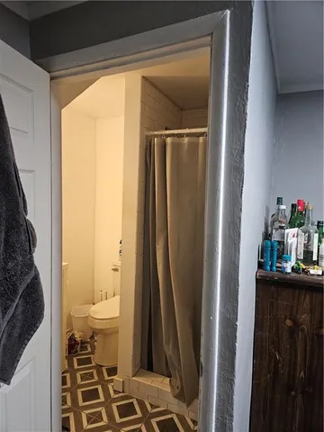 a bathroom with a sink a toilet and a shower