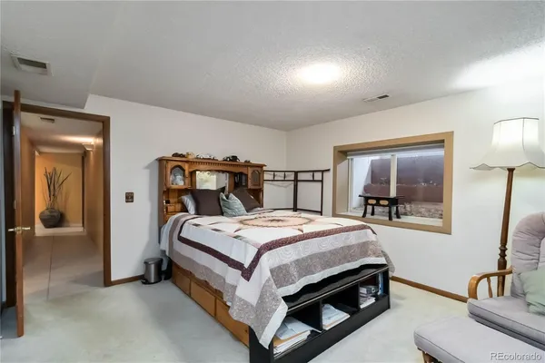 a bedroom with a bed and a mirror