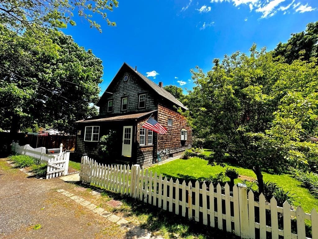 4 Sutton Place Worcester, MA 01603 - Photo 1 of 32 a view of a brick house with large trees and wooden fence