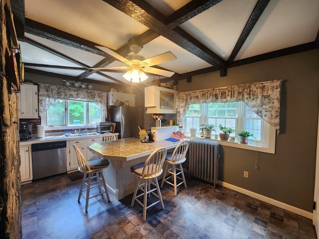 4 Sutton Place Worcester, MA 01603 - Photo 13 of 32 a kitchen with a table and chairs in it