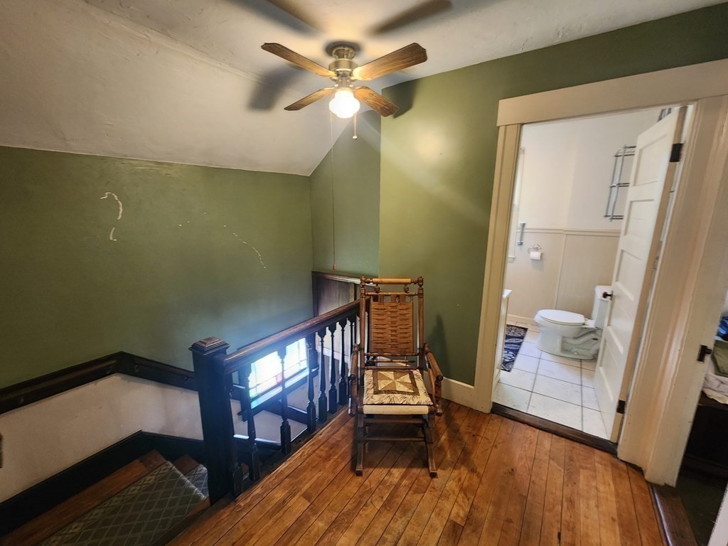 4 Sutton Place Worcester, MA 01603 - Photo 20 of 32 a view of an empty room with wooden floor and a ceiling fan