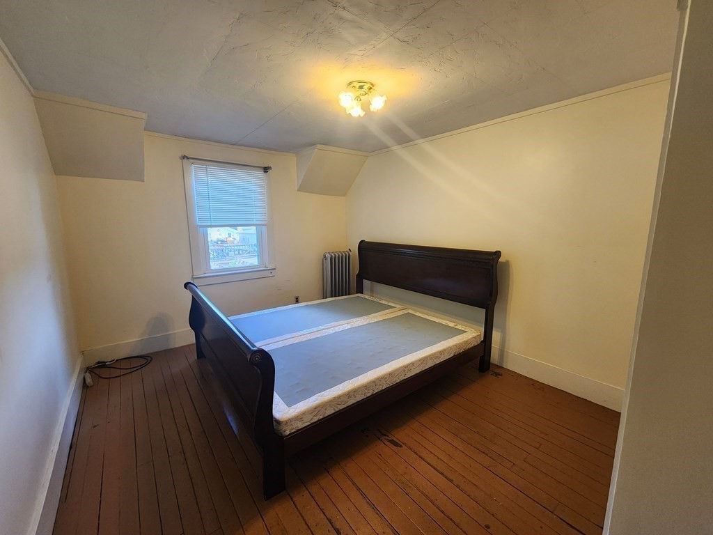 4 Sutton Place Worcester, MA 01603 - Photo 23 of 32 a bedroom with a bed and a window