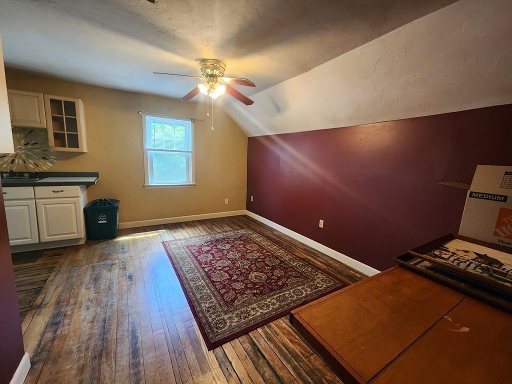 4 Sutton Place Worcester, MA 01603 - Photo 25 of 32 a living room with hard wood floors and a rug