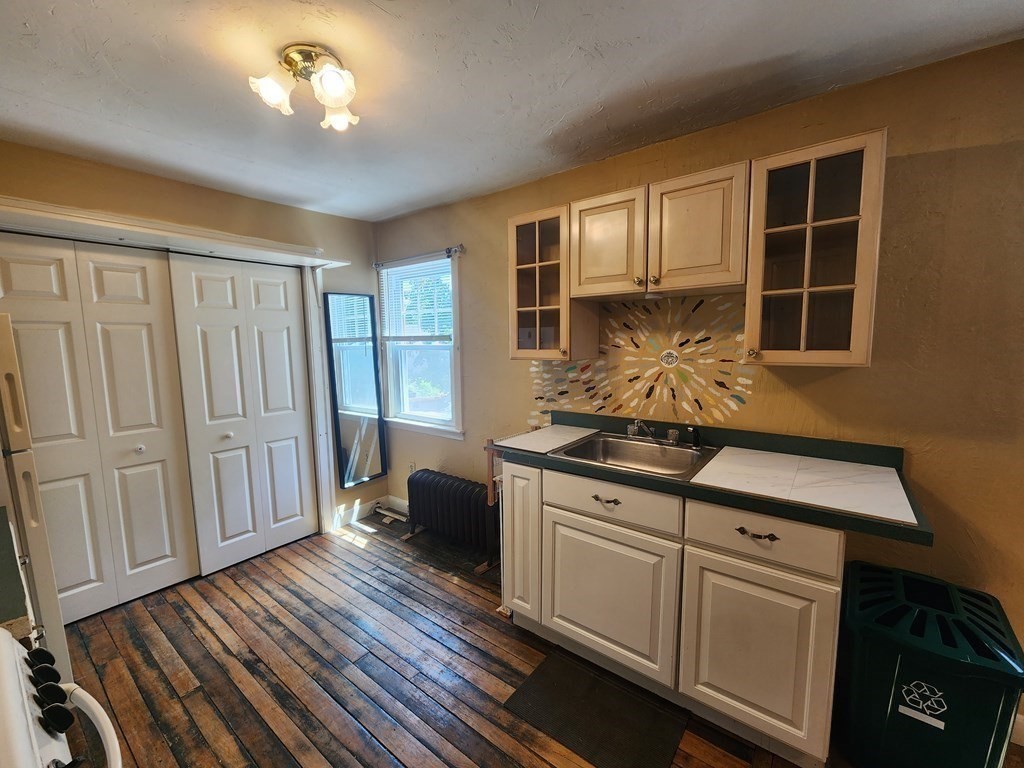 4 Sutton Place Worcester, MA 01603 - Photo 27 of 32 a kitchen with stainless steel appliances granite countertop a stove and a sink