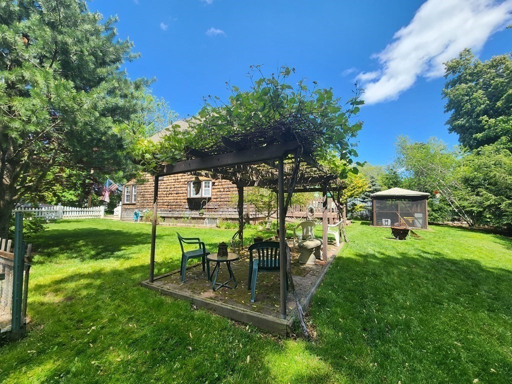 4 Sutton Place Worcester, MA 01603 - Photo 7 of 32 a view of a backyard with table and chairs potted plants and large tree
