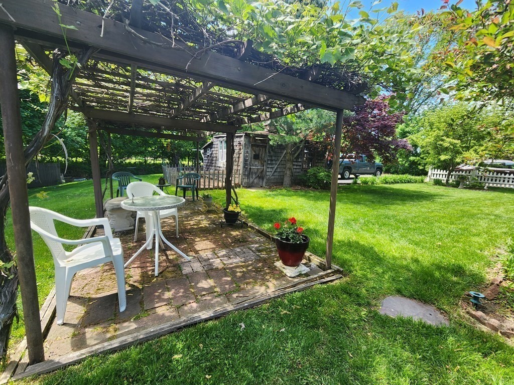 4 Sutton Place Worcester, MA 01603 - Photo 9 of 32 a view of a table and chairs in backyard of the house