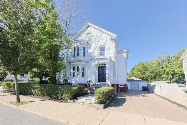 a view of a house with a garden and pathway