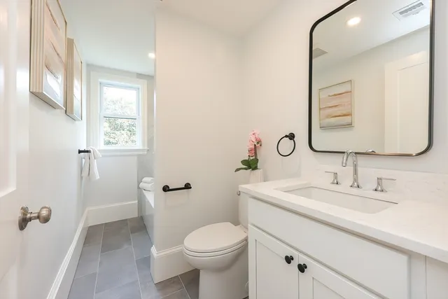a bathroom with a sink toilet and mirror