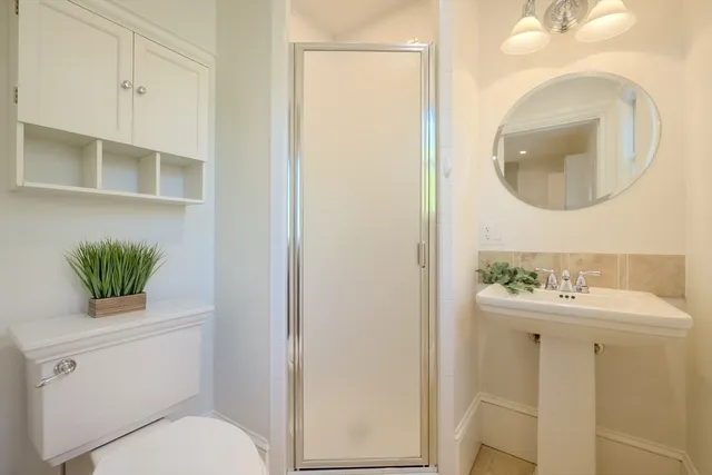 a bathroom with a sink toilet and a mirror