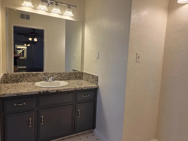 a view of a hallway with wooden floor and closet