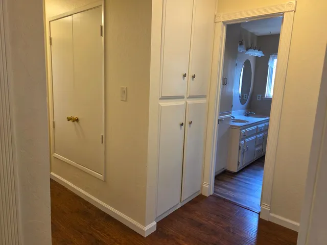 en empty room with window and chandelier fan