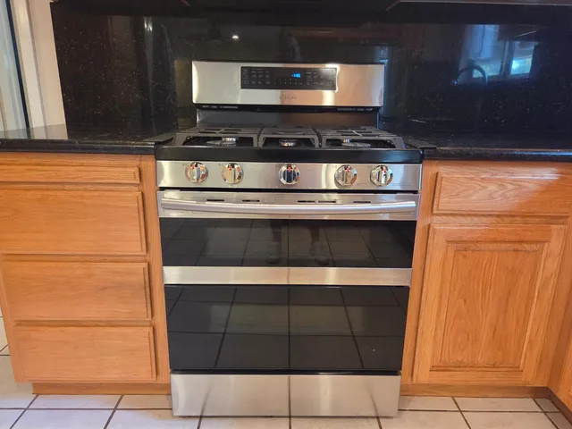 a kitchen with granite countertop a sink and a cabinets