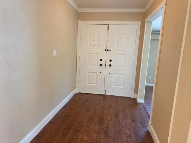a view of room with window and wooden floor