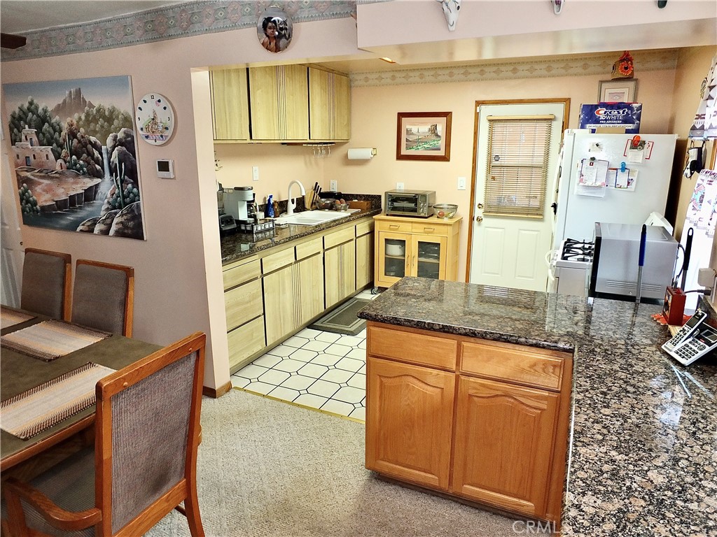 4907 139th Street Hawthorne, CA 90250 - Photo 19 of 47 a kitchen with stainless steel appliances granite countertop a sink stove and refrigerator